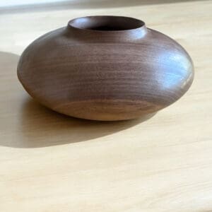 A wooden bowl sitting on top of a table.