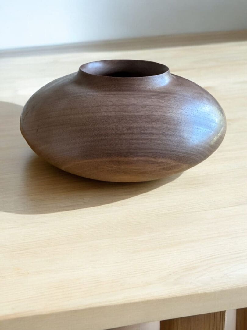 A wooden bowl sitting on top of a table.