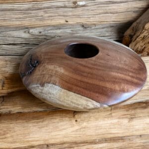 A wooden bowl sitting on top of a table.