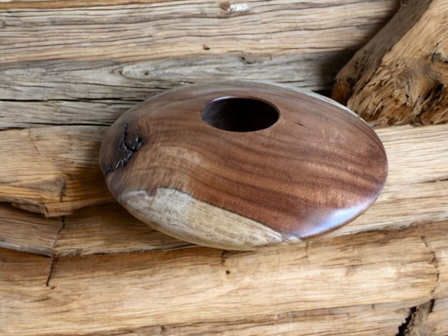 A wooden bowl sitting on top of a table.